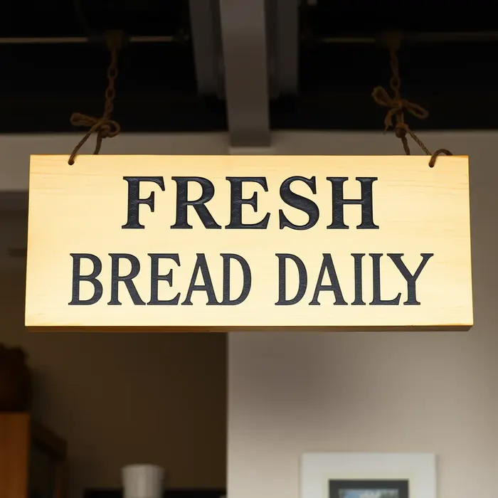 A wooden sign reading FRESH BREAD DAILY